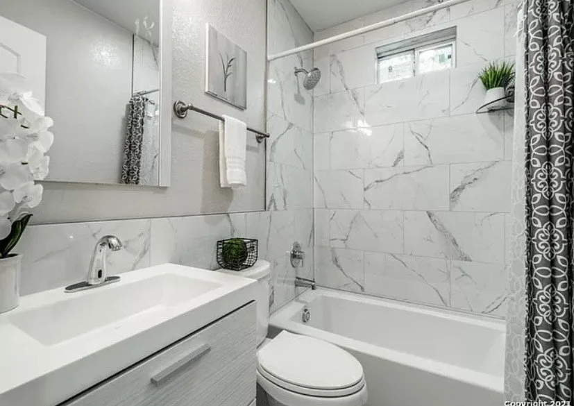 Renovated bathroom with marble-look tile shower
